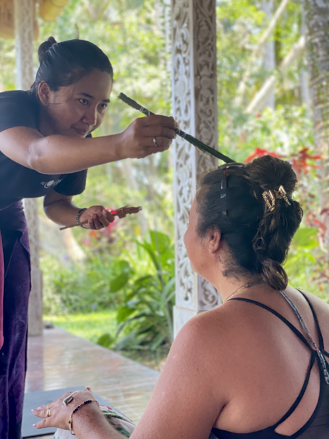 A participant receiving a traditional Balinese blessing