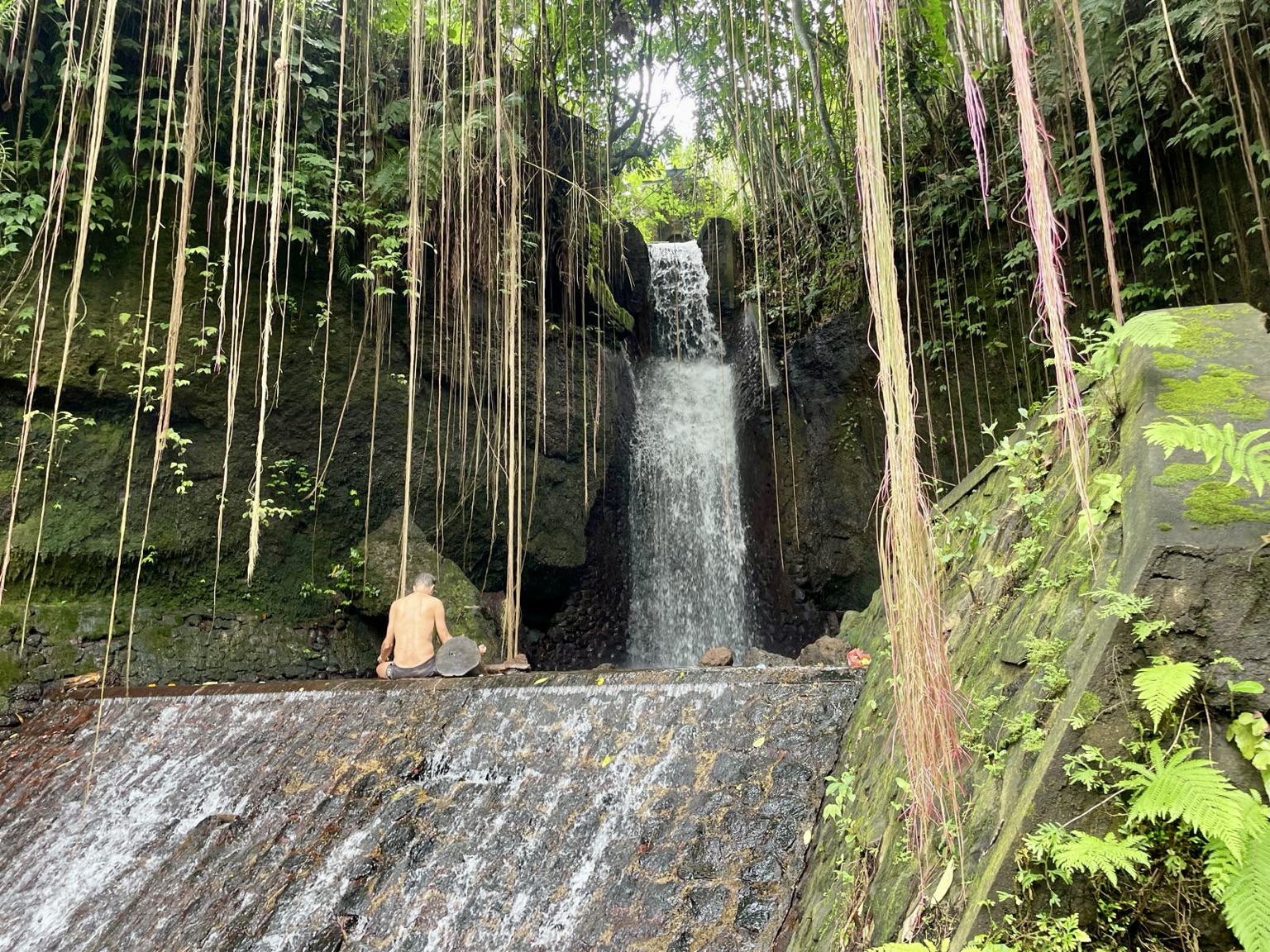 Marc beside a waterfall in Bali