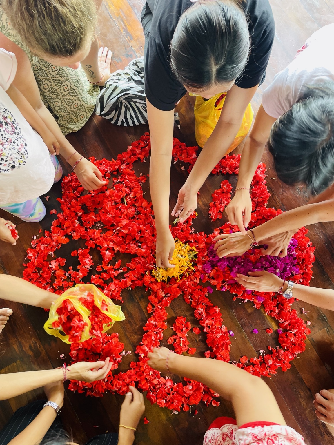 Participants creating a flower mandala together in Bali