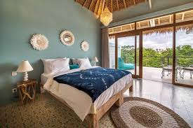 A peaceful bedroom overlooking tropical greenery